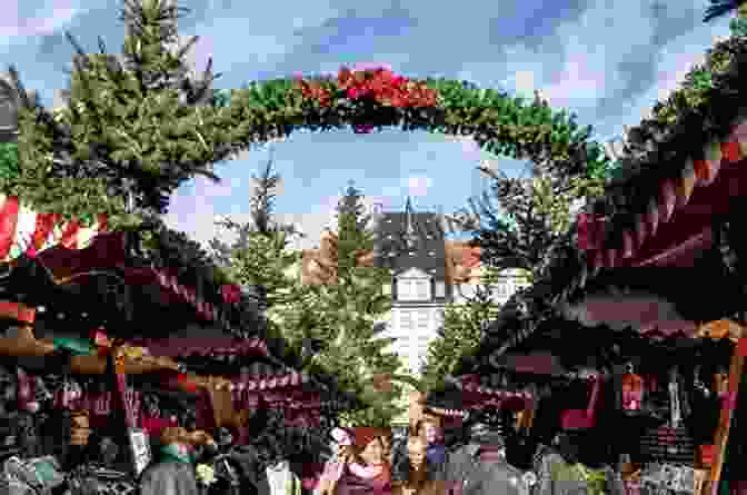 A Bustling German Christmas Market With Wooden Stalls, Festive Decorations, And People Browsing. Christmas Traditions Upile Chisala